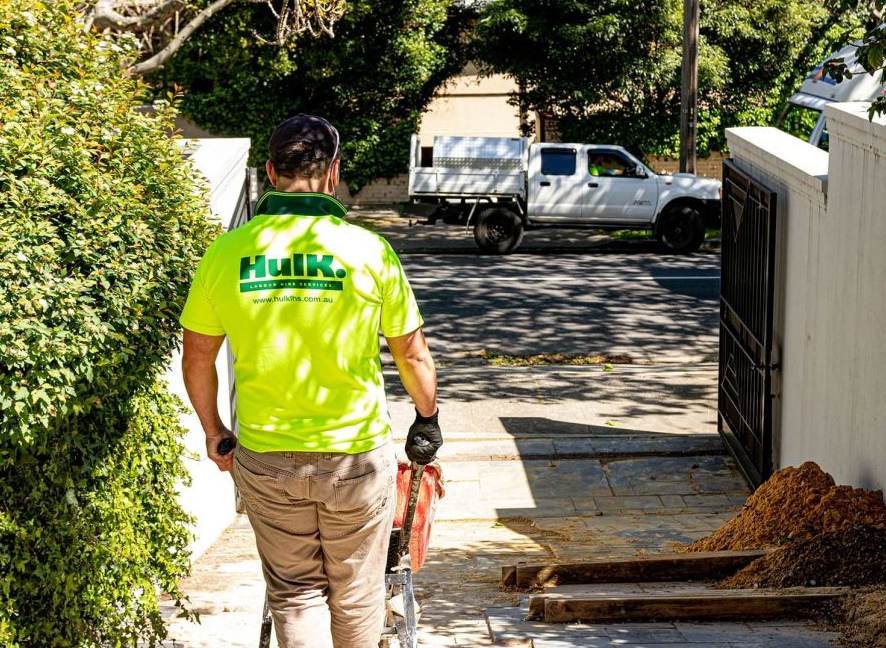 Hulk crew member moving materials on site